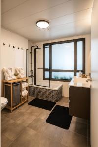 a bathroom with a sink and a toilet and a window at דירת נופש נוף לכנרת in Migdal