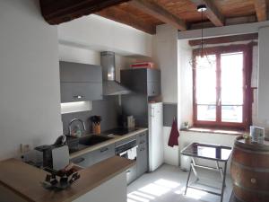 a kitchen with a sink and a table and a window at Escapade lauragaise in Saint-Félix-Lauragais