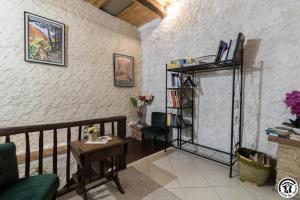 a living room with a table and a shelf with books at Escapade lauragaise in Saint-Félix-Lauragais