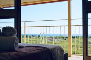 a bedroom with a large window with a view of the ocean at B&b Biagio 2 Managed by Calabria Mare Experience in Cirella