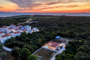 una vista aérea de una casa en el bosque al atardecer en Villa Relax Petrčane, en Petrčane