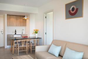 a living room with a couch and a table at Aparthotel Marina Drach in Porto Cristo