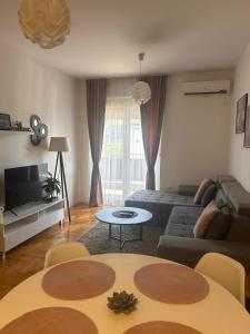 a living room with a couch and a table at Apartment ''Dream&Relax'' Trebinje in Trebinje