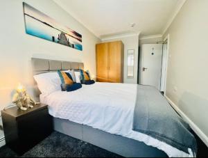 a bedroom with a large white bed in a room at Spacious 6 Bedroom House with Free Parking for Contractors and Business in Basildon