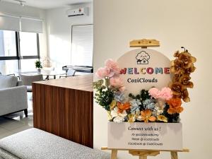 a welcome sign in a room with flowers and balloons at NEW Designer Condo - Panoramic Forest View - Steps To IOI City Mall - Your Best Urban Retreat in Putrajaya