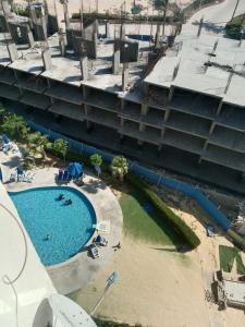 an overhead view of a swimming pool next to a building at قريه بورتو جولف مارينا in El Alamein +9 photos