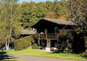a log cabin with a porch and a porch at Haus 2 - Typ B (Blockhaus) in Schönecken