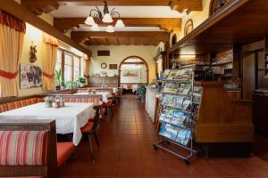 a restaurant with tables and chairs in a room at Embacherhof in Embach