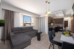a living room with a couch and a table at United Cretan Villas in Agia Marina Nea Kydonias