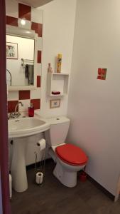 a bathroom with a red toilet and a sink at Chambres D'hôtes Le Bellevue - in Montbrun-les-Bains +26 photos
