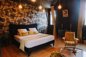 a bedroom with a bed and a wall with a mural at le petit château de Célestine in Segonzac +60 photos