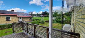 a balcony with a view of a house with solar panels at Lilla Villa Svanö in Lunde