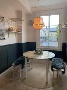 a dining room with a table and a window at The Green House in Norrtälje