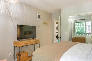 RathdrumにあるTwin Lakes Retreat Lake and Golf Access!のベッドと薄型テレビのある寝室