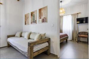 a living room with a bed in a room at Wood in White in Panormos Skopelos