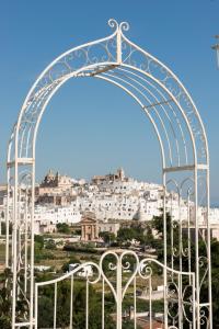 an arch with a view of a city at Biancadamare in Ostuni