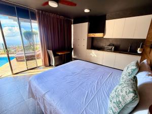 a bedroom with a bed and a view of the ocean at Unique suite piscine vue mer in Faaa