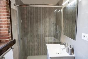 a bathroom with a glass shower and a sink at Tenuta Madre Vita in Syracuse +30 photos