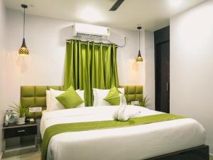 a bedroom with a large bed with a white bird on it at Hotel Raventa in kolkata +13 photos
