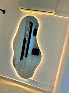 a hallway with a circular light on the wall at Hotel Santa Sofia in Bucaramanga