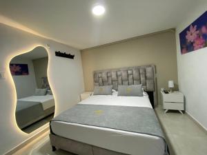 a bedroom with a large bed with a curved headboard at Hotel Santa Sofia in Bucaramanga +45 photos