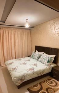 a bedroom with a bed with a pillow and a window at Cozy apartment in Ifrane in Ifrane +5 photos