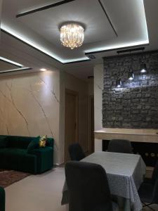 a living room with a green couch and a table at Cozy apartment in Ifrane in Ifrane