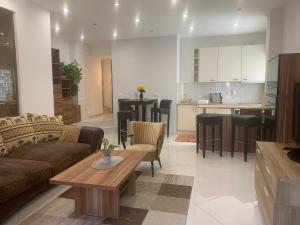 a living room and kitchen with a couch and a table at Seven‘S Apartments I in Löhnberg