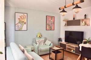 a living room with a couch and a tv at Villa Zen in Majanicho