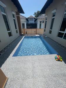 a swimming pool in the backyard of a house at D Aur Poolvilla Seaview in Bachok +4 photos