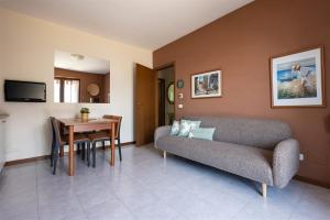 a living room with a couch and a table at IseoLakeRental - Casa Amici in Riva di Solto