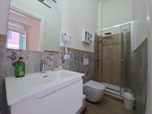 a bathroom with a sink and a shower and a toilet at La Maison dello Stretto in Messina +32 photos