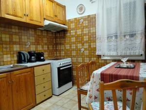 a small kitchen with a table and a stove at Αστερόεσσα in Katapola