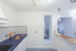 a kitchen with a counter top and a sink at Wellness HM al Corso By Dimorra in Naples +17 photos