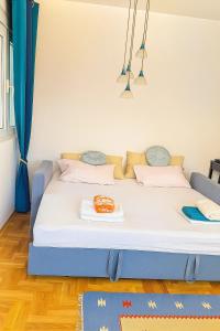 a large bed in a room with blue curtains at Million Star Apartment in Budva