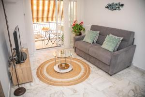 a living room with a couch and a table at Appartement Spacieux au Port de Nice avec Clim et Parking Gratuit in Nice