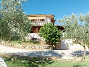 a large building with trees in front of it at Locazione Turistica Spaccarotella Terrazzo con Vista su Gualdo Cattaneo in Gualdo Cattaneo