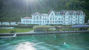 a large white building sitting on top of a body of water at Studio Annecy in Annecy