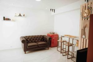 a living room with a couch and a red fire hydrant at Studio Annecy in Annecy
