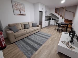 a living room with a couch and a table at Casa do Sardão in Sardoal