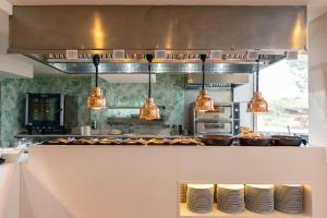 a kitchen with some pots and pans on a counter at Invisa Hotel Club Cala Verde in Es Figueral Beach