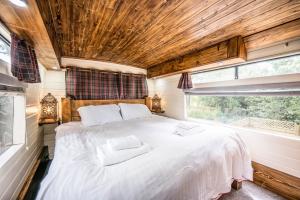 a bedroom with a large bed in a tiny house at The Bus Stop, Thornham Magna in Thornham Magna
