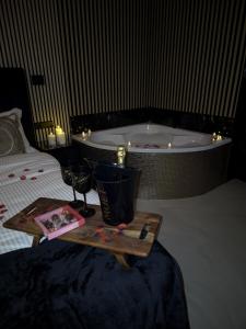 a bed with a tray with a candle and a bath tub at Hotel Broer & Zus in The Hague +58 photos