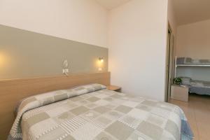 Voodi või voodid majutusasutuse Hotel Colonna toas