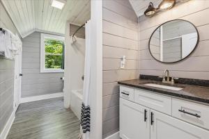 a bathroom with a sink and a mirror at Amazing Views, Hot Tub, Arcade & Firepit in Gatlinburg +43 photos