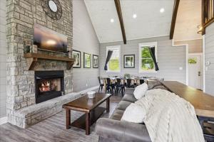 a living room with a couch and a fireplace at Amazing Views, Hot Tub, Arcade & Firepit in Gatlinburg