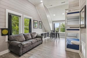 a living room with a couch and a bunk bed at Amazing Views, Hot Tub, Arcade & Firepit in Gatlinburg