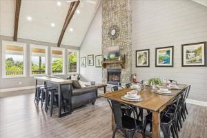 a living room with a table and a fireplace at Amazing Views, Hot Tub, Arcade & Firepit in Gatlinburg