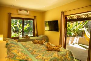 a bedroom with a bed with teddy bears on it at Forest House Pipa in Pipa