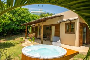 a hot tub in the yard of a house at Forest House Pipa in Pipa